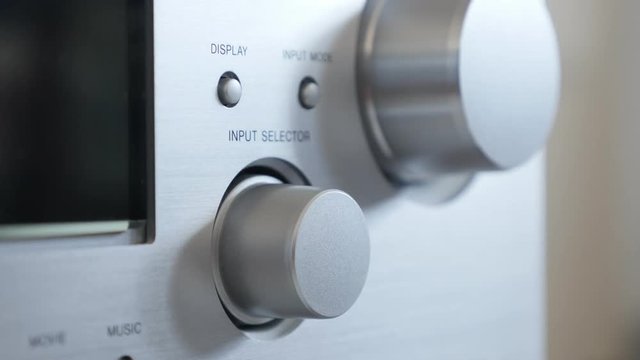 Silver finish Hi-Fi design amp changing sources close-up 2160p 30fps UltraHD footage - Audio device in aluminum color using dial for options 3840X2160 UHD video