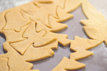 Abstract Christmas food background with cookies molds and flour. Baking Christmas cookies - table, cookie cutters and cookies.