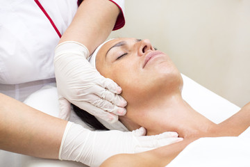 Fototapeta na wymiar Process of massage and facials in beauty salon