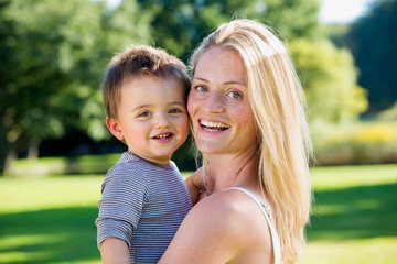 Adorable boy in striped shirt with woman.