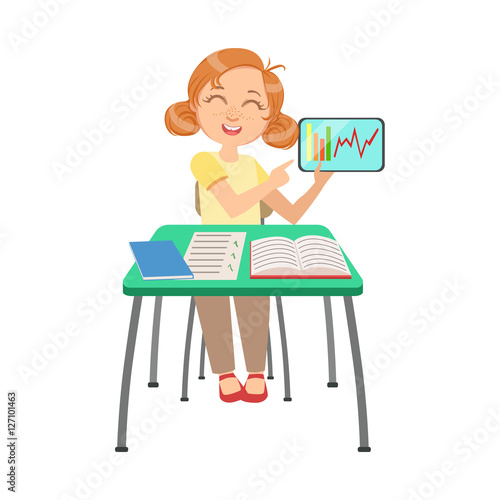 Schoolgirl Sitting Behind The Desk In School Class Showing Chart