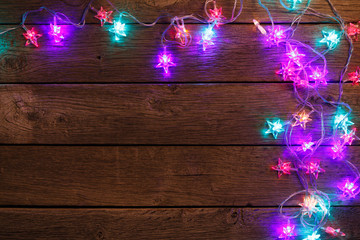 christmas lights border on wood background