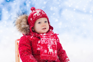 Kids play in snow. Winter sleigh ride for children