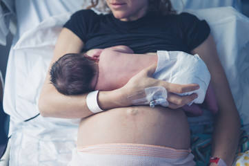 mother breastfeeding her baby - obrazy, fototapety, plakaty