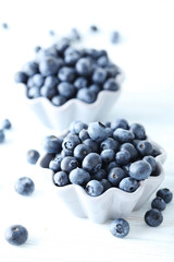 Ripe and tasty blueberries on blue wooden table