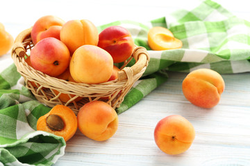 Fototapeta na wymiar Ripe apricots fruit on white wooden table