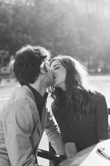 Young beautiful couple in love kissing outdoor in back light - love, relationship, kiss concept. Black and white
