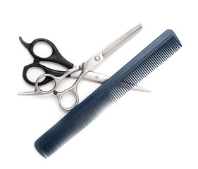 Comb with scissors on a white background