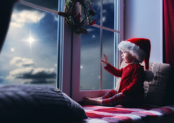 baby girl sitting by the window