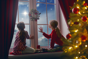 girls sitting by window