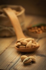 Almonds on brown wooden background