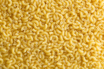 Pasta raw closeup background. Delicious dry uncooked ingredient for traditional Italian cuisine dish. Textured variety shapes. Top view. Copy space