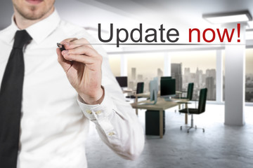 businessman writing update now in the air