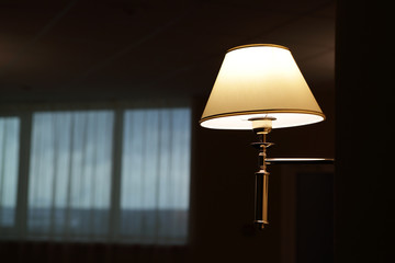 Lamp on wall in hallway at night