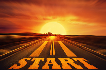 Word Start written on an asphalt road and two arrows as motivation. Long way ahead as a concept of...
