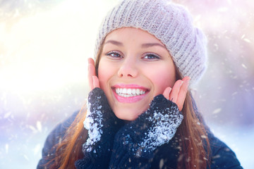 Joyful beauty girl having fun in winter park