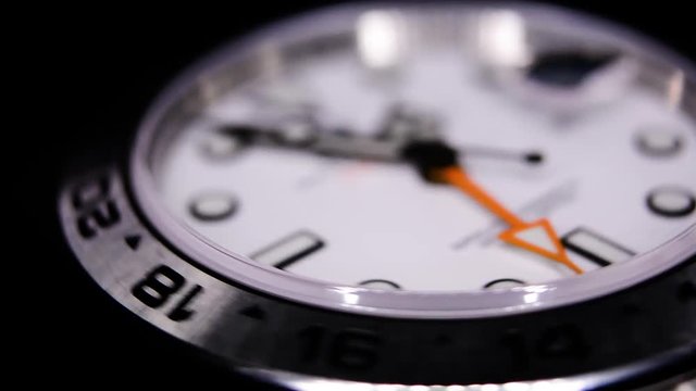 Extreme close-up of white luxury watch in a watch winder
