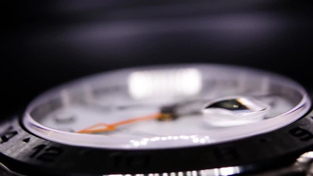 Extreme close-up of white luxury watch spinning in a watch winder