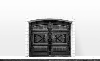 Old wooden gate in a white wall