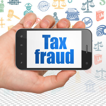 Law concept: Hand Holding Smartphone with Tax Fraud on display