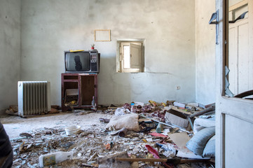 Room destroyed with furniture and old television
