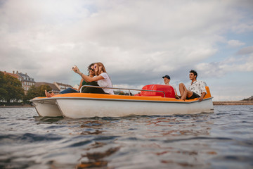 Group of people in boat taking selfie