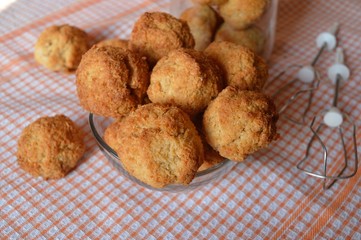 Homemade, golden spherical coconut cookies