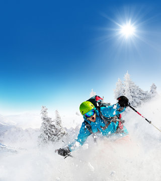 Freeride skier on piste running downhill