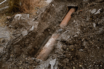 Old Rusty Pipe for water in a trench open for repair top view
