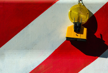 Red and White Concrete Jersey Road Barrier with Warning Light