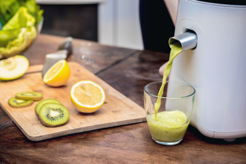 Juicer and juice with fresh fruits and vegetables