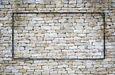 Single blank frame hanged against ancient stone wall background