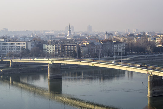 the image of the city car bridge through the wide river