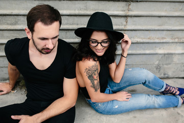 man and woman posing on a background gray wall