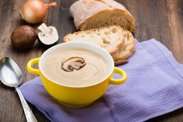 Mushroom cream soup on the wooden table.