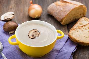 Mushroom cream soup on the wooden table.
