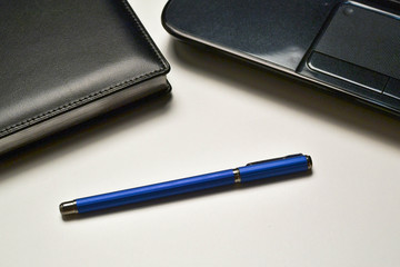 laptop, notebook and pen