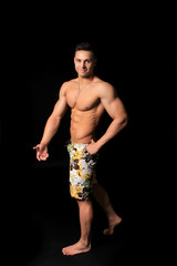 Fototapeta na wymiar handsome bodybuilder man in shorts showing muscles