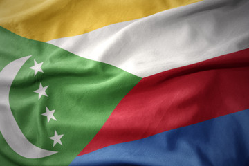 Obraz premium waving colorful flag of comoros.