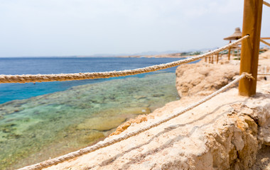 View of the sea with corals and reefs through a small wooden fen