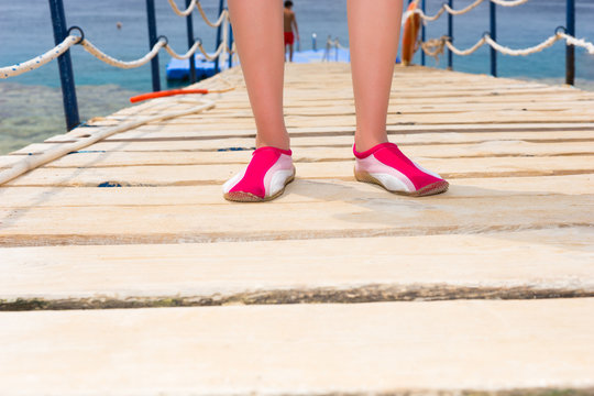 Female feet in pink slippers
