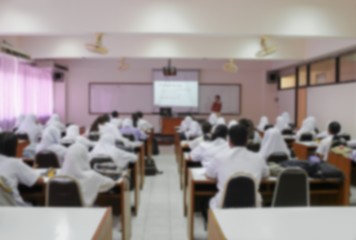  blurred focus, students sitting in a lecture room with the teacher