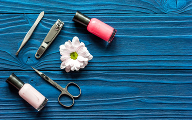 nail polish and spa manicure set on dark wooden background