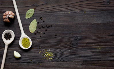 spices in spoon on wooden table top view