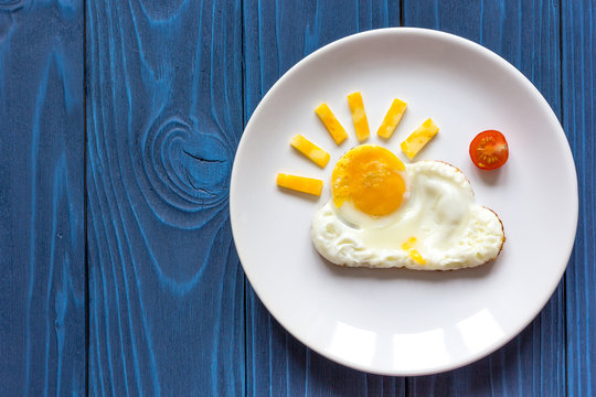 sunshine fried eggs breakfast for kid on blue background