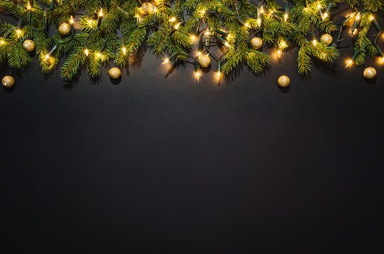 Christmas decoration background over black chalkboard, top view. Horizontal photo of decorations taken from above with copy space for text and other web or print design elements.