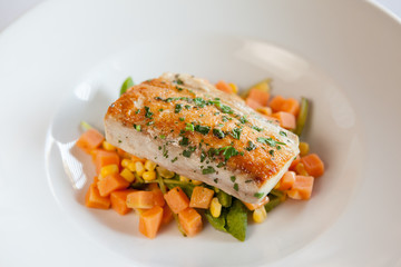 Seared salmon over a bed of diced carrots