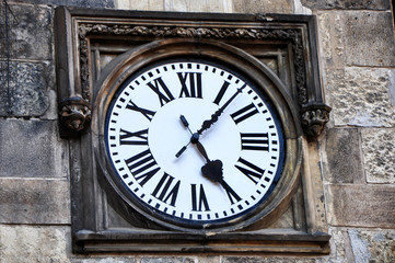 Fototapeta na wymiar Detail from the stone wall,street clock.