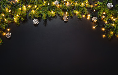 Christmas decoration background over black chalkboard, top view. Horizontal photo of decorations...