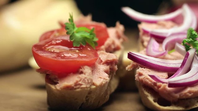 Man puts pate on the bread. Man puts pate with the silver knife on a slice of bread